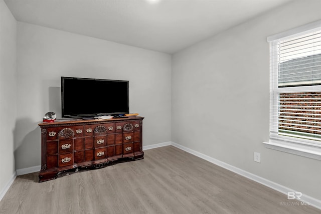 bedroom featuring light hardwood / wood-style floors and multiple windows