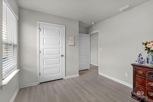 unfurnished bedroom featuring light wood-type flooring