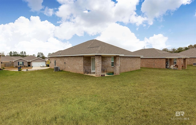 rear view of house with a lawn, a patio area, and cooling unit