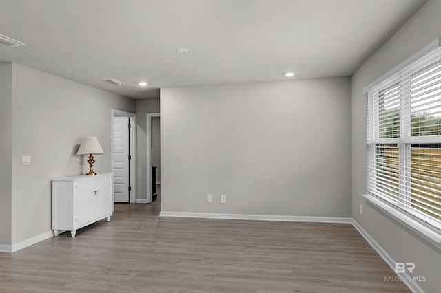 unfurnished room with wood-type flooring