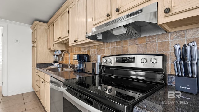 331 E 2nd Ave, Gulf Shores, AL 36542 - kitchen with appliances with stainless steel finishes, a sink, under cabinet range hood, dark countertops, and decorative backsplash