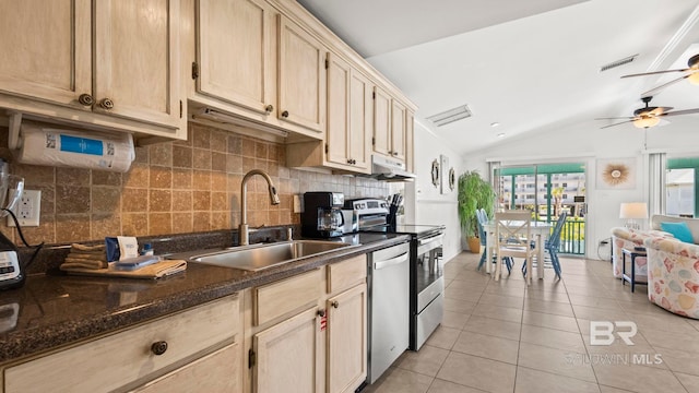 331 E 2nd Ave, Gulf Shores, AL 36542 - kitchen featuring a sink, lofted ceiling, appliances with stainless steel finishes, light tile patterned floors, and decorative backsplash