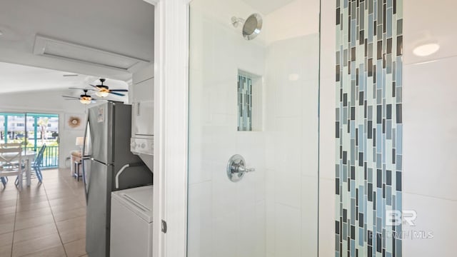 331 E 2nd Ave, Gulf Shores, AL 36542 - full bathroom featuring a shower stall, stacked washer / drying machine, vaulted ceiling, tile patterned floors, and a ceiling fan