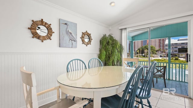 331 E 2nd Ave, Gulf Shores, AL 36542 - dining room with vaulted ceiling, crown molding, tile patterned flooring, and a wainscoted wall