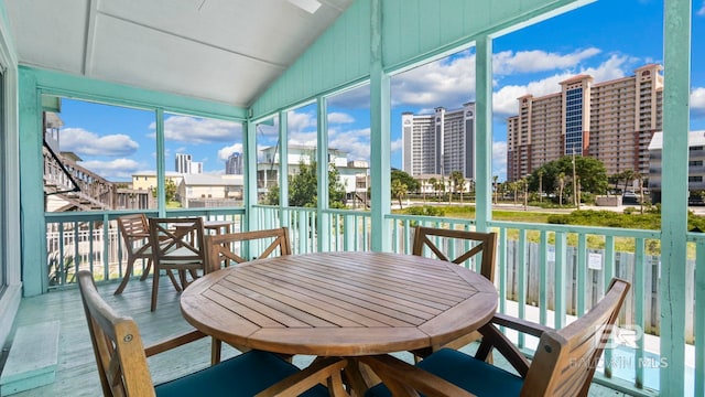 331 E 2nd Ave, Gulf Shores, AL 36542 - sunroom / solarium featuring vaulted ceiling and a city view