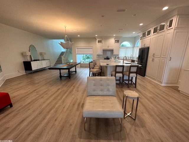 living room featuring light hardwood / wood-style flooring and sink