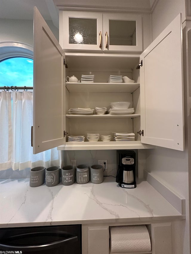 interior space with white cabinets and light stone countertops