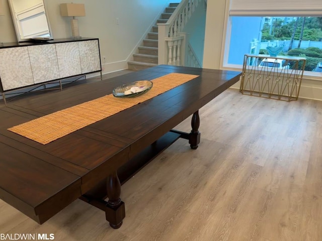 dining space with light hardwood / wood-style floors