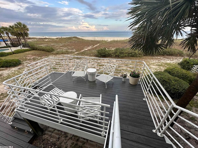 wooden terrace featuring a water view