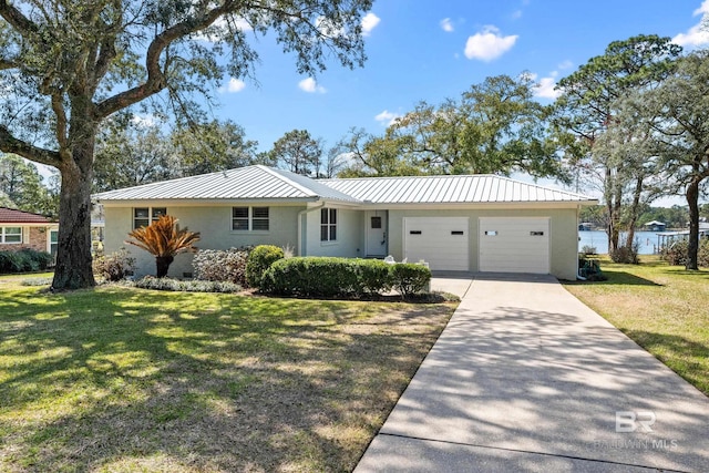 single story home featuring driveway, metal roof, an attached garage, a front lawn, and stucco siding