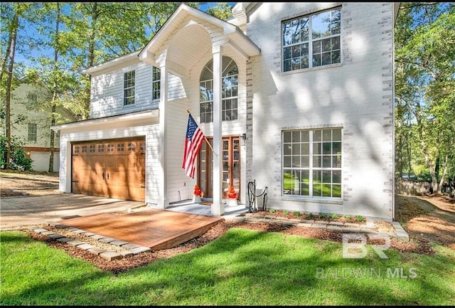 view of front of property with a garage and a front yard