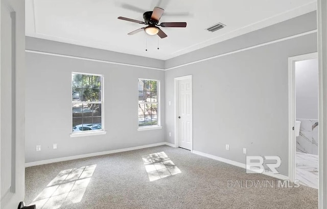 empty room featuring ceiling fan and carpet