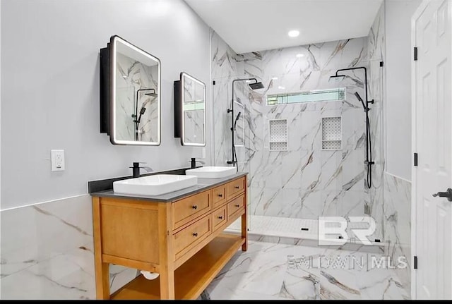 bathroom featuring vanity and a tile shower