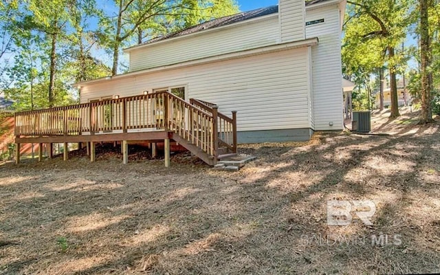 back of house with a wooden deck and cooling unit