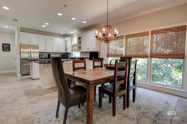 tiled dining area featuring an inviting chandelier and ornamental molding