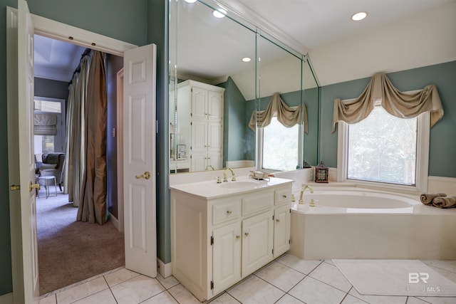 bathroom with a washtub, tile patterned flooring, vanity, and a healthy amount of sunlight