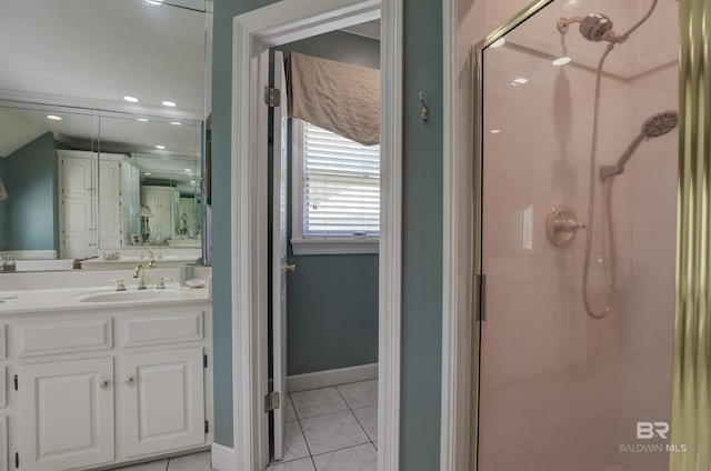 bathroom featuring tile patterned flooring, a shower with door, and vanity