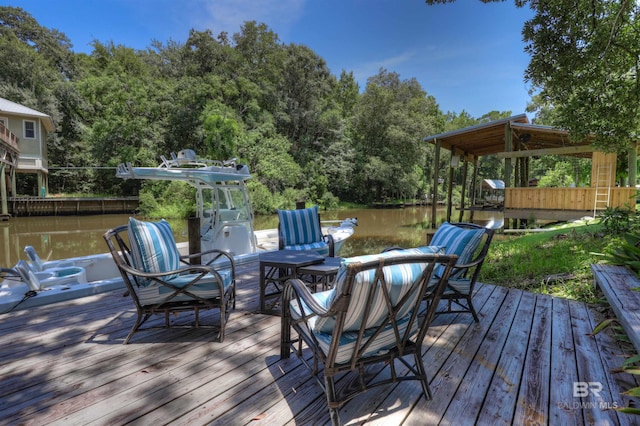 wooden deck featuring a boat dock and a water view