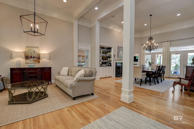 living room with light wood-type flooring, crown molding, and beamed ceiling