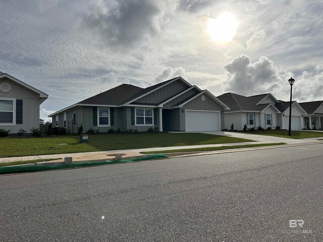 view of front of home featuring a front yard and a garage