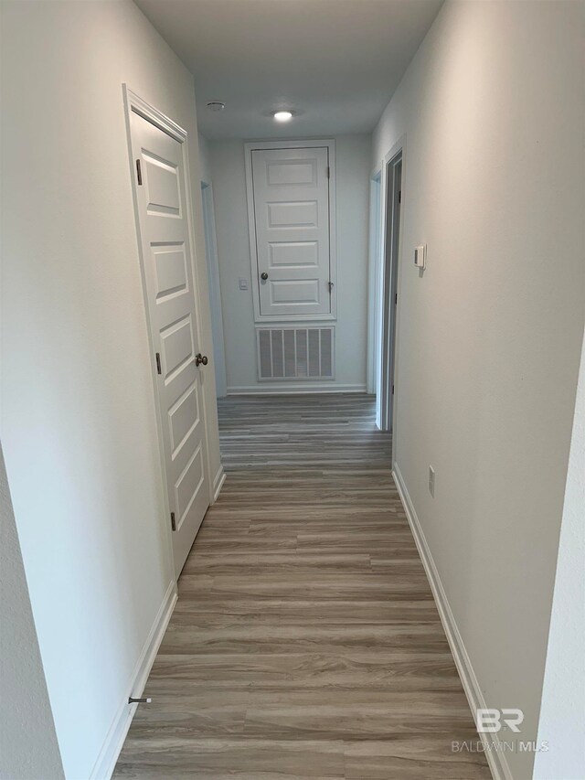 hall with hardwood / wood-style floors