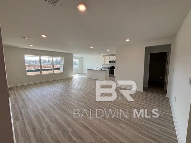 unfurnished living room featuring light hardwood / wood-style floors