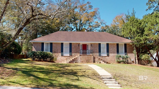 single story home featuring brick siding and a front yard