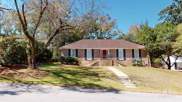 single story home with brick siding and a front yard
