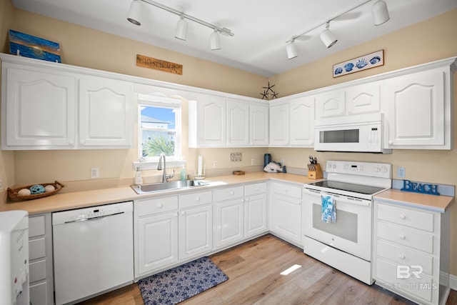 kitchen featuring a sink, white appliances, light wood-style floors, and white cabinetry