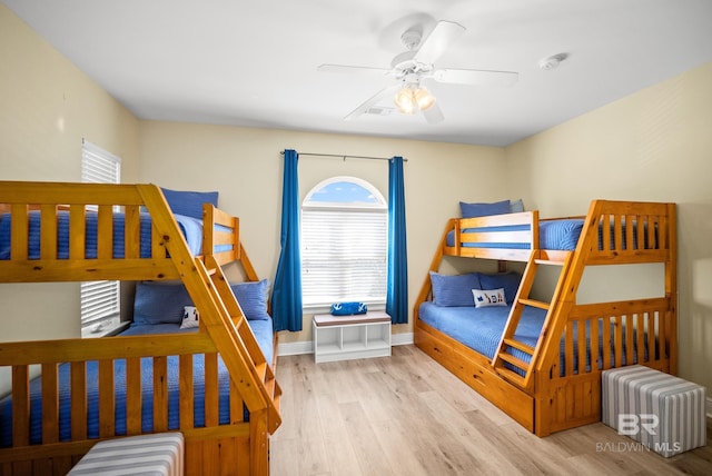 bedroom featuring ceiling fan, baseboards, and wood finished floors