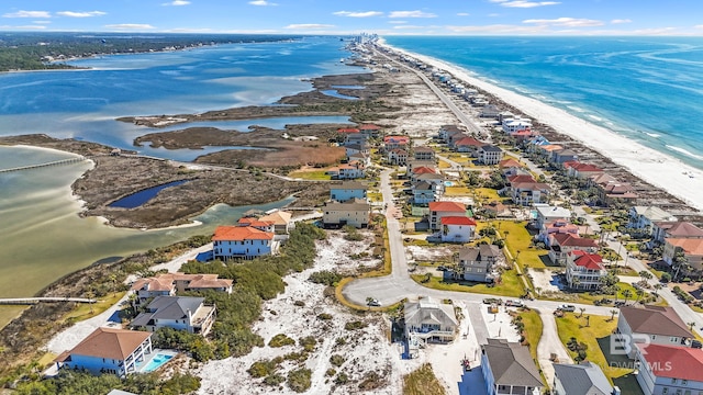 drone / aerial view featuring a residential view, a view of the beach, and a water view