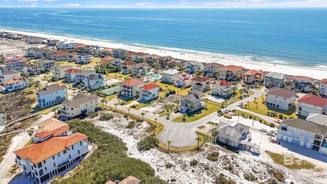 drone / aerial view with a residential view, a view of the beach, and a water view