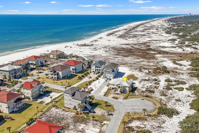 bird's eye view with a view of the beach, a water view, and a residential view