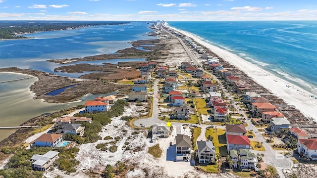 drone / aerial view with a residential view, a beach view, and a water view