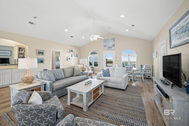 living room with vaulted ceiling, recessed lighting, visible vents, and wood finished floors