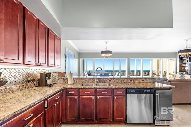 kitchen with reddish brown cabinets, dishwasher, light stone counters, an inviting chandelier, and a sink