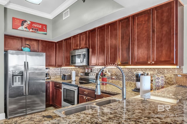 kitchen with visible vents, appliances with stainless steel finishes, light stone counters, ornamental molding, and dark brown cabinets