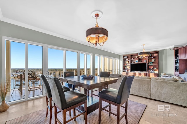 dining area featuring ornamental molding and a notable chandelier