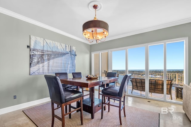 tiled dining space with ornamental molding, a chandelier, and baseboards