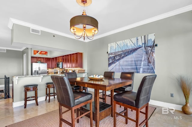 dining area with light tile patterned flooring, a notable chandelier, visible vents, baseboards, and crown molding