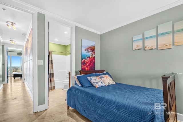 bedroom featuring baseboards, ornamental molding, and ensuite bathroom