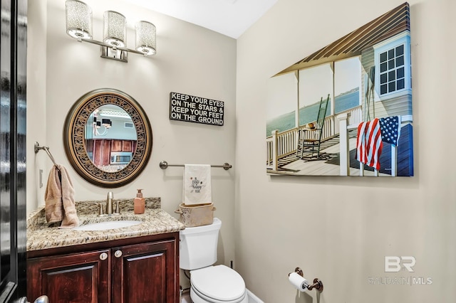 bathroom featuring vanity and toilet