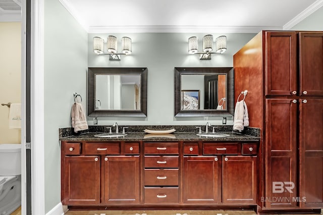 full bath with crown molding, a sink, toilet, and double vanity