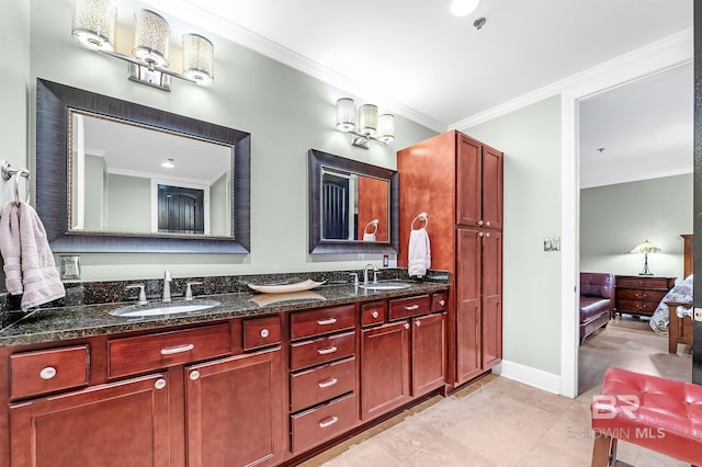 full bath featuring ornamental molding, a sink, baseboards, and double vanity