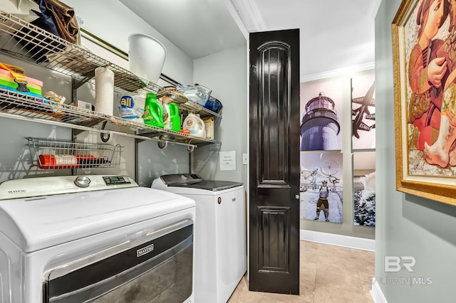 clothes washing area featuring baseboards, laundry area, ornamental molding, and washer and dryer