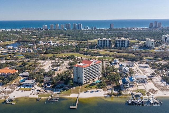 birds eye view of property with a water view and a city view