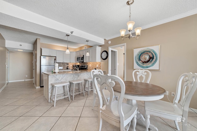 24720 Perdido Beach Blvd Unit 504, Orange Beach, AL 36561 - dining area with light tile patterned flooring, a textured ceiling, a chandelier, ornamental molding, and baseboards