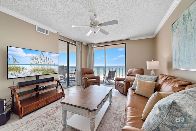 24720 Perdido Beach Blvd Unit 504, Orange Beach, AL 36561 - living room with a textured ceiling, ceiling fan, a water view, light tile patterned floors, and ornamental molding