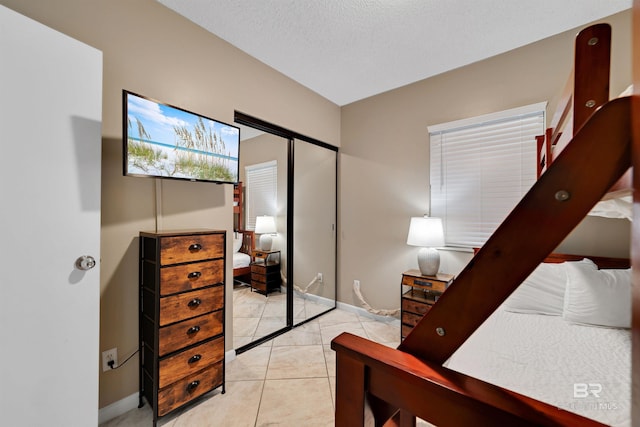 24720 Perdido Beach Blvd Unit 504, Orange Beach, AL 36561 - bedroom with baseboards and light tile patterned floors