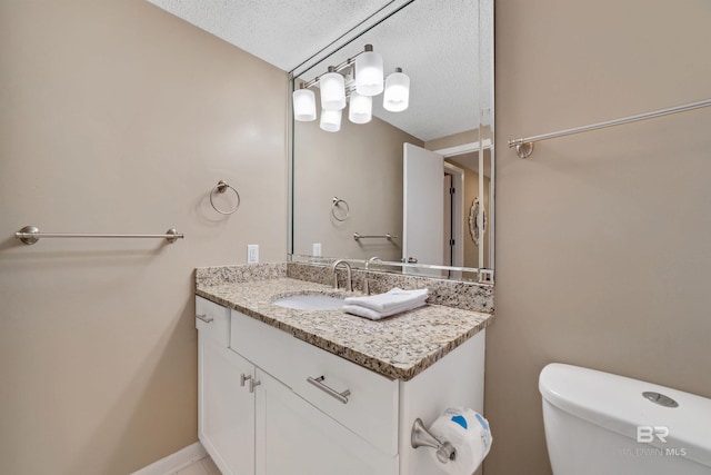 24720 Perdido Beach Blvd Unit 504, Orange Beach, AL 36561 - half bath with a textured ceiling, vanity, and toilet